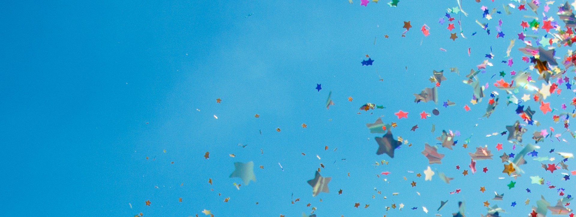 Celebration confetti in blue sky