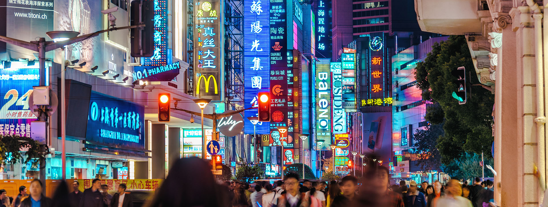 busy street at night with neon signs