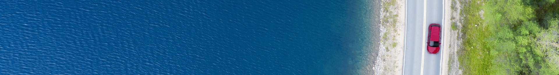 Car driving by the sea