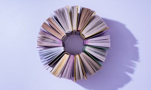 books in a circle with purple background