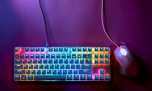 gaming keyboard and mouse on purple background